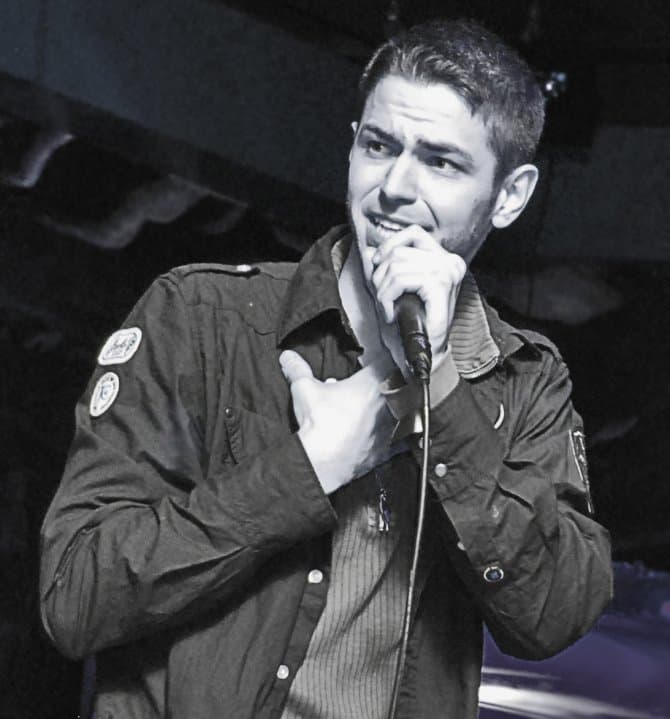 Jared Volle performing stand-up comedy on stage